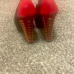 Red bottom shoes worn multiple times.